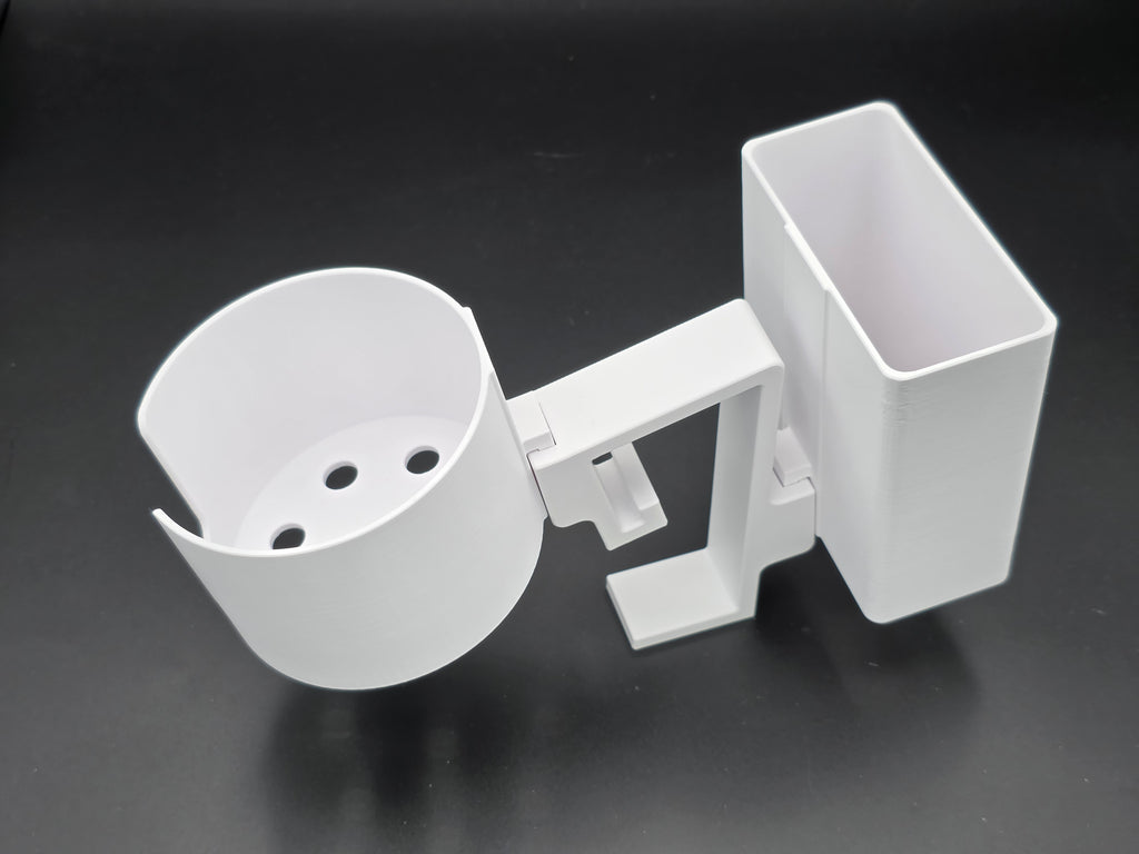 A studio-style shot of a single white, 3D-printed cup and cell phone holder attachment for a Tarter poly stock tank, isolated against a smooth black background. The cup holder features a deep cylindrical cup with five drainage holes at the bottom and a large side notch for mug handles. The cell phone holder is rectangular with rounded corners. Both holders are connected to a sturdy, integrated L-shaped mounting clip designed to hook over a thick tank rim, showcasing the smooth finish.