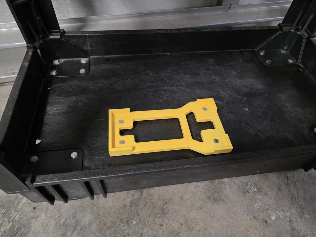 A 3D printed cradle for the Active 2.0 pressure washer power head shown in yellow with included stainless hardware. The image is a close-up of the cradle installed on an a black Kobalt branded utility cart. 