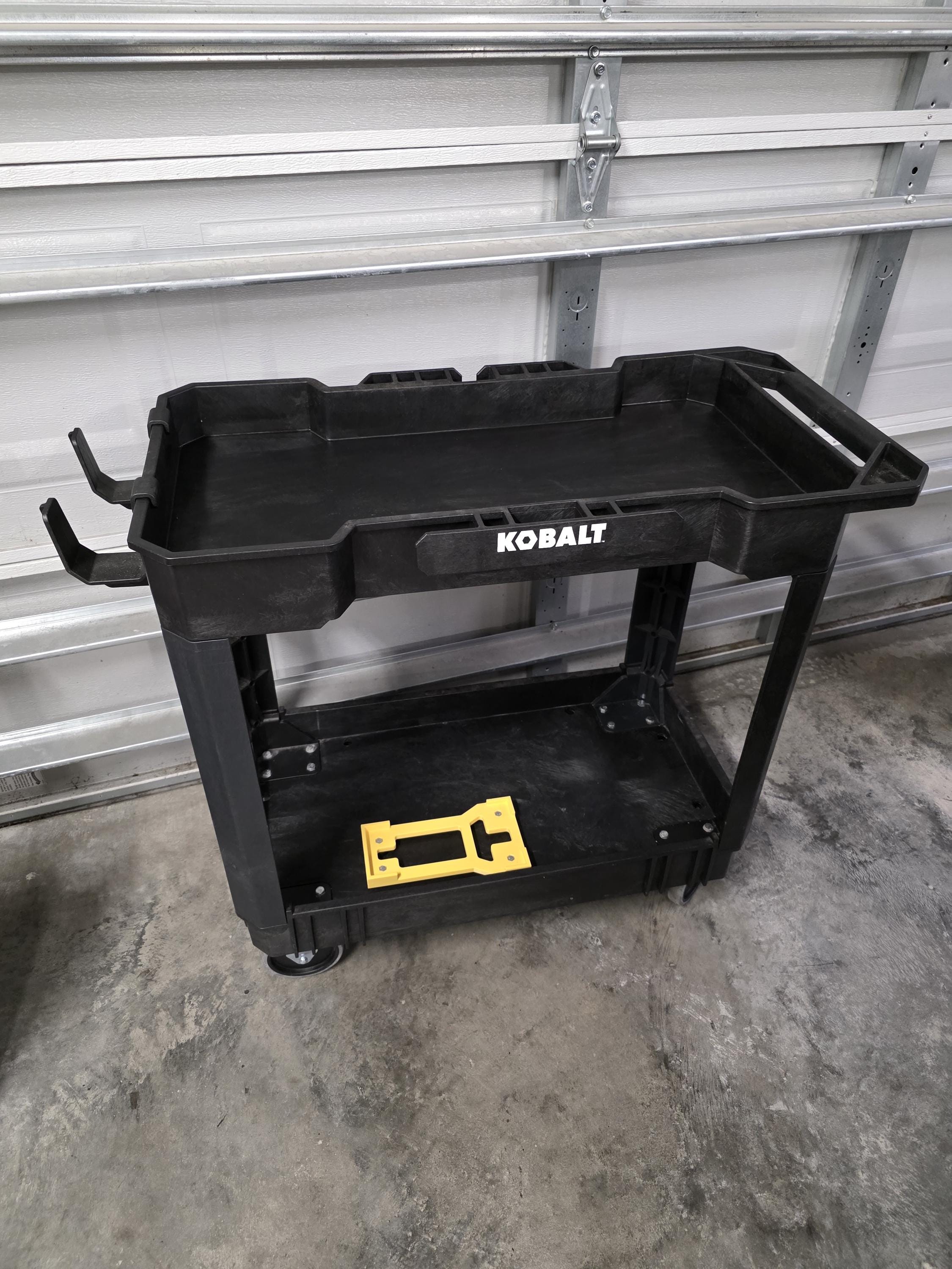 A 3D printed cradle for the Active 2.0 pressure washer power head shown in yellow with included stainless hardware and installed on a black Kobalt branded utility cart. 