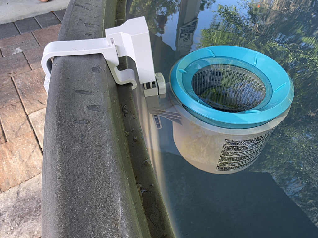A close-up image of an Intex above ground pool skimmer installed onto a grey poly stock tank using a grey 3D printed bracket and a grey adapter to the Intex skimmer support rod. 